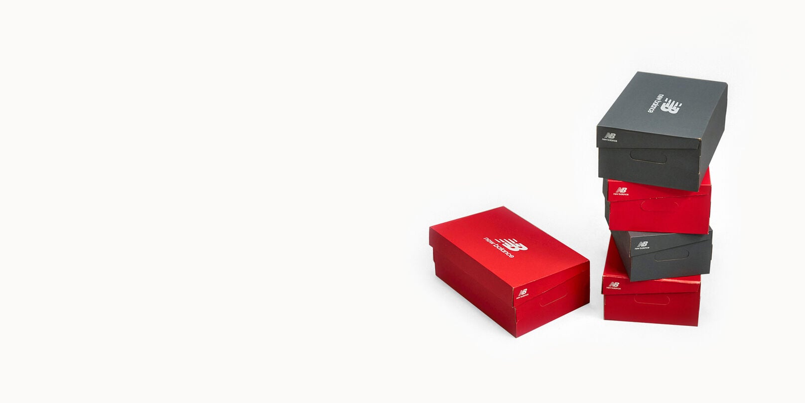 New Balance red and gray shoe boxes stacked. 